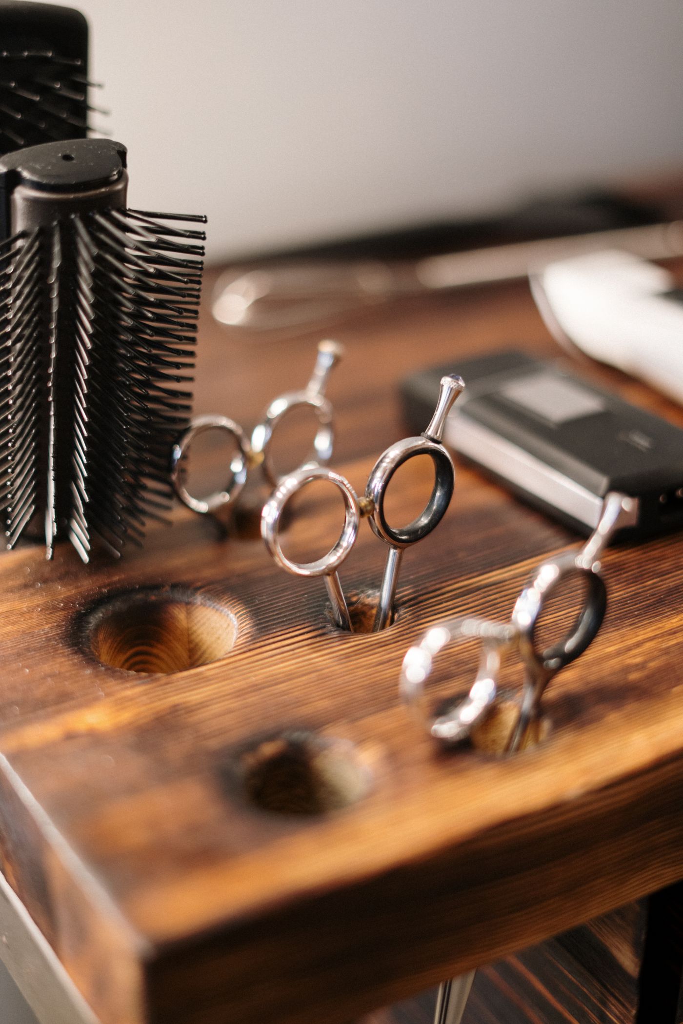 Barber scissors resting on a wooden block