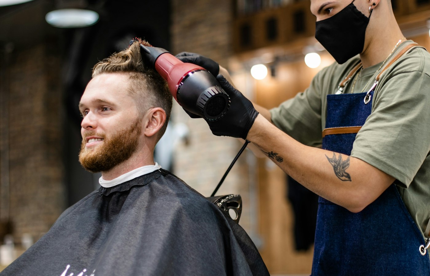 Barber blow-drying and styling hair